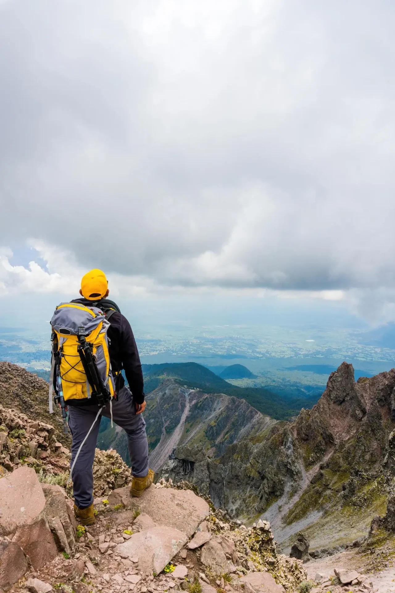 hiker-with-backpack-standing-top-mountain