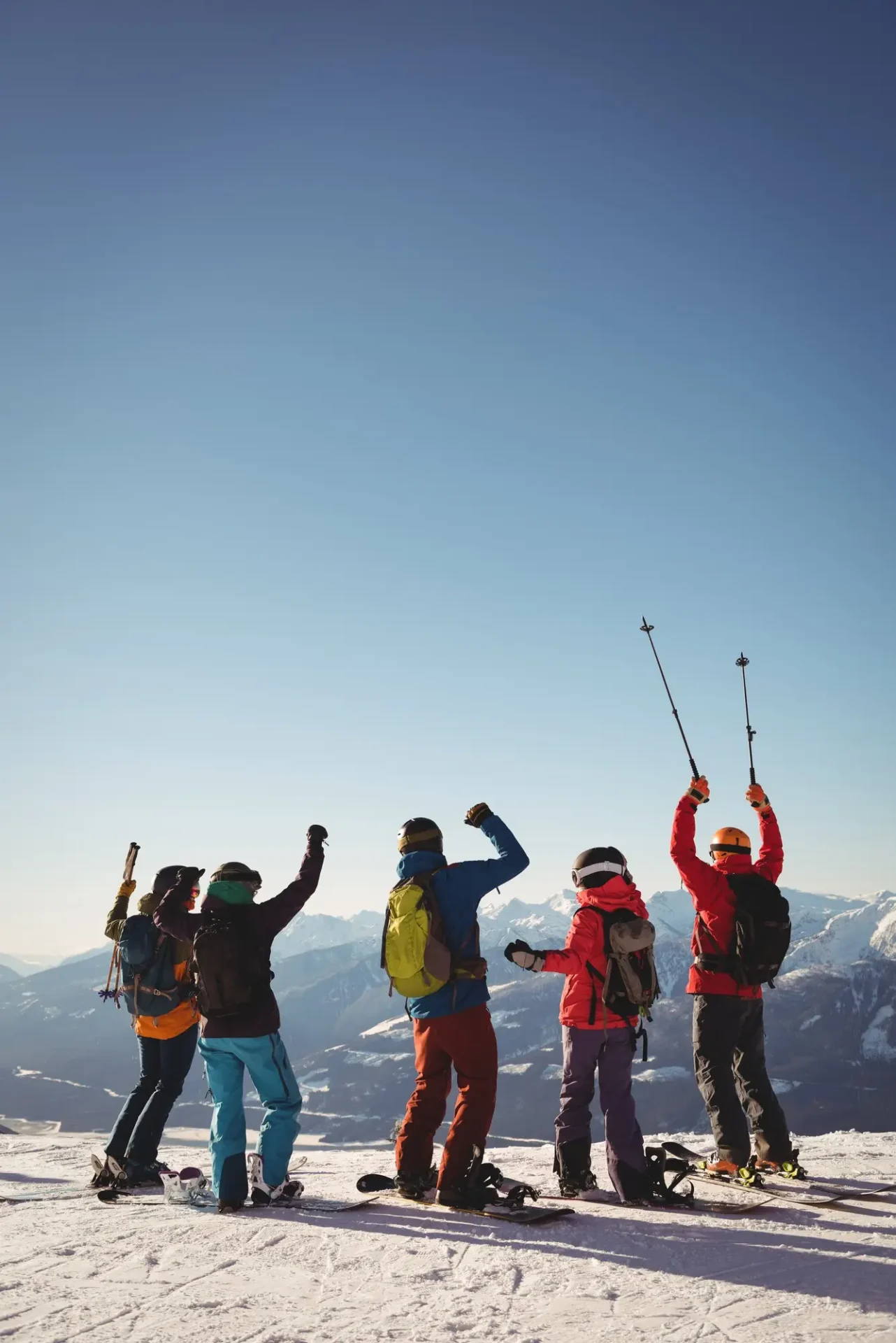 celebrating-skiers-standing-snow-covered-mountain